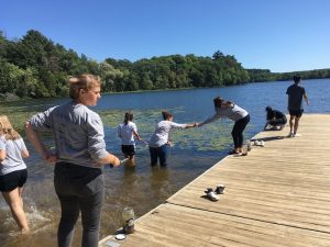 saint john's prep students in lake for class project