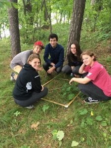 saint john's prep students doing a science project in the woods