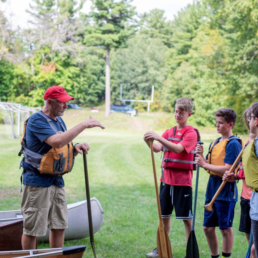 Students at Saint John's Prep get a lesson in paddling a canoe as part of a holistic education.